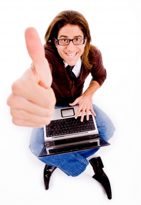 Top View Of Smiling Man With Thumbs Up And Laptop by imagerymajestic on freedigitalphotos.net